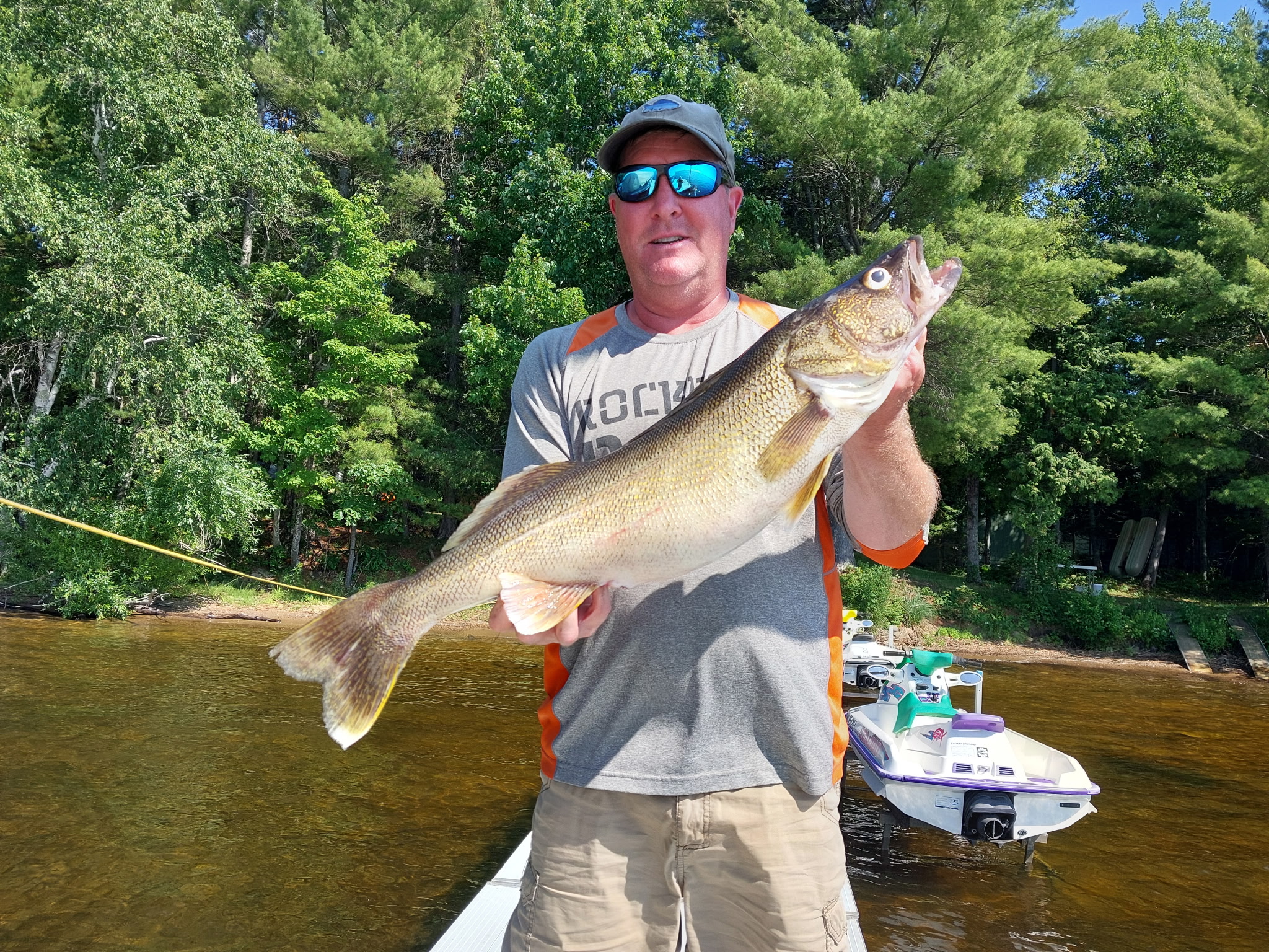 Steve holding a 29-inch walleye caught on Portage Lake